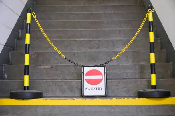 No entry sign and yellow chain in front of stair steps uk