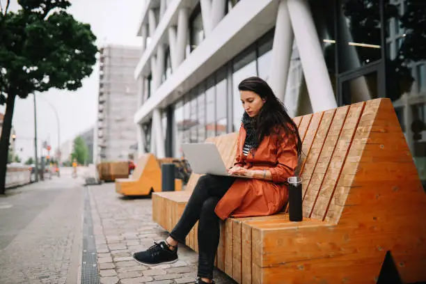 Photo of young woman working on the go in Berlin