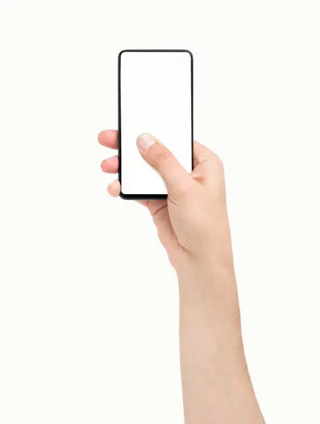 Man hand holding and touching a mobile phone screen with his thumb on a white isolated background