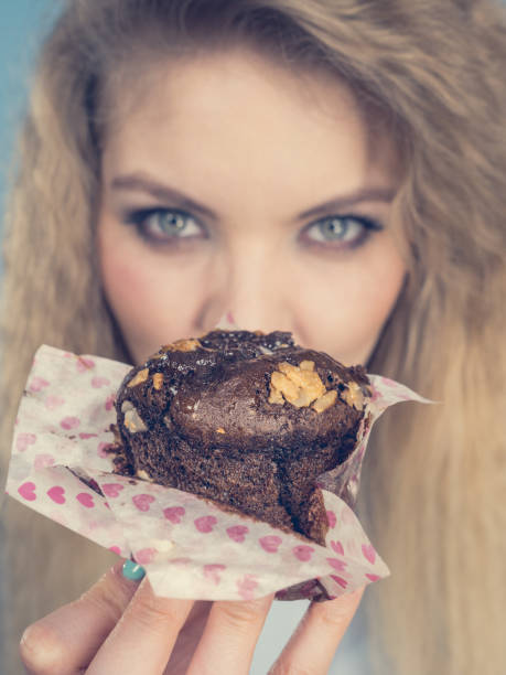 istock Attractive woman holds cake in hand 1156160894