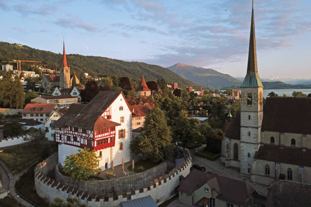 Aerial of Zug, Switzerland Aerial drone image of Zug, Switzerland with focus on the Zug Castle, Catholic Church of St Oswald and St Michel further in the background. keep fortified tower photos stock pictures, royalty-free photos & images