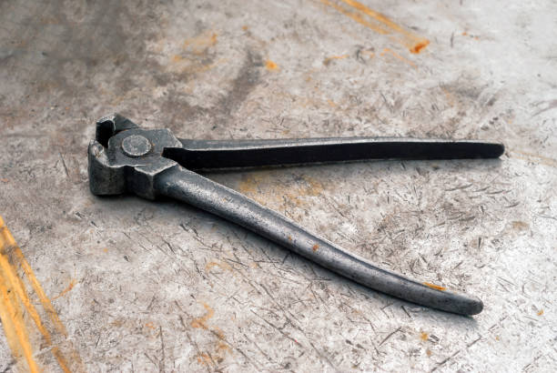 istock old pincers on a metal workbench 1156162180