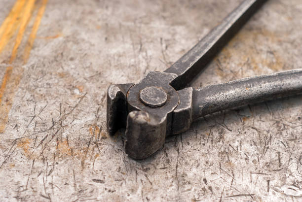 istock old pincers on a metal workbench 1156162185