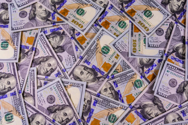istock Background of the many american one hundred dollar banknotes 1156162425
