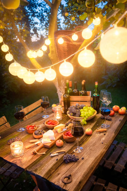 istock Table full of appetizers and wine in illuminated garden 1156163785