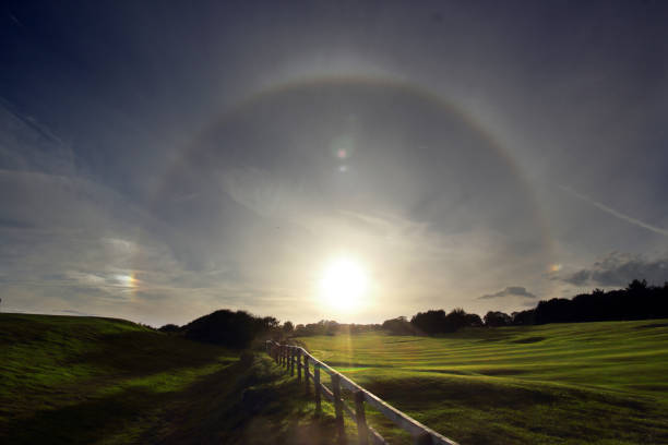 Sun halo at Alnmouth, Northumberland A beautiful sun halo (22 degree) with sundogs. Taken near Alnwick in Northumberland. sundog stock pictures, royalty-free photos & images