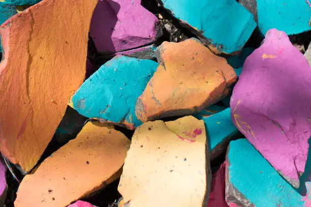 Colorful stones background. Bright colors of rocks. Blue, orange, pink color background.