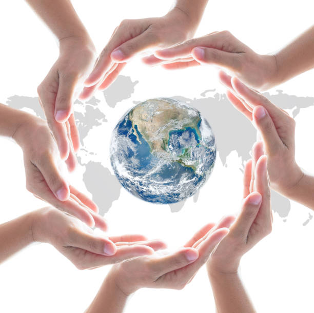 istock Collaborative people's hands surrounding globe world map for community empowerment concept. Elements of this image furnished by NASA 1156171468