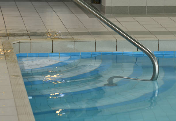 istock Swimming Pool Steps and Railing Entrance Close Up Abstract 1156171499