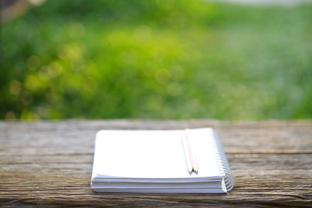 istock white notebook and pencil on wooden table 1156172108