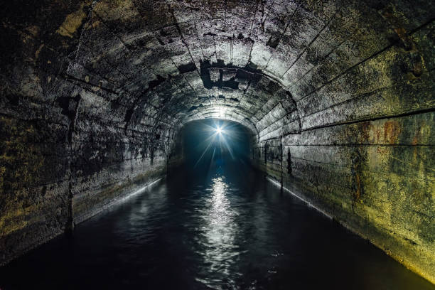 istock Dark flooded concrete vaulted drainage mine tunnel 1156175622
