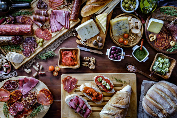 istock Tapas of cured ham and cheese delicious appetizer on rustic wood table with copy space 1156186821