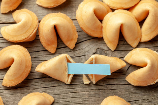 istock Chinese fortune cookies. Cookies with empty blank inside for prediction words. Background of old wooden table. 1156204721