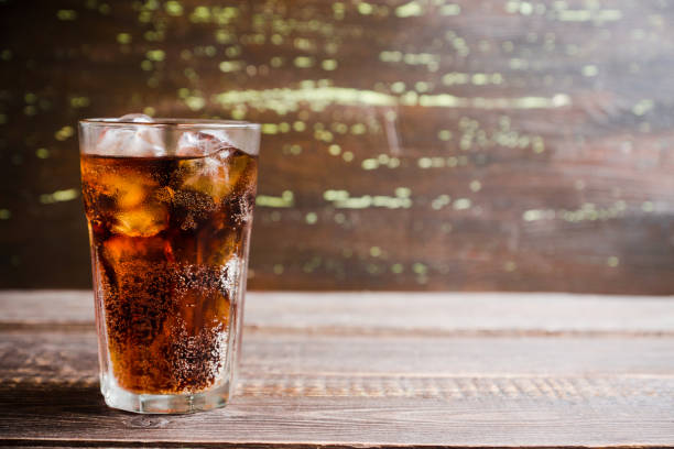 istock Refreshing cold cherry cola on the wooden background 1156205586