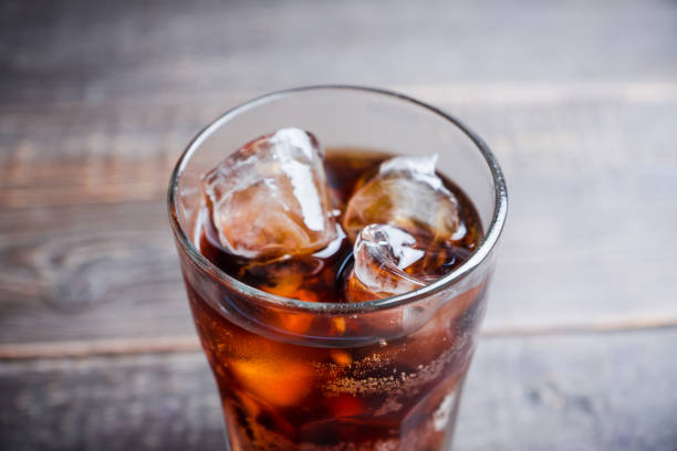 istock Refreshing cold cherry cola on the wooden background 1156205587
