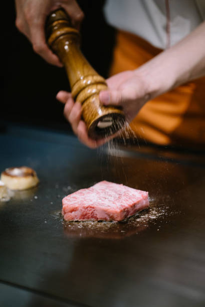 chef sprinkling salt and pepper on marbled beef - asia cooked food gourmet imagens e fotografias de stock