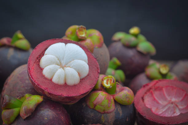 istock Mangosteen fruit cut into half with seeds. 1156210927