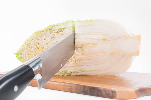 Fresh ripe Chinese cabbage and knife on the cutting board. Ready for cooking. Fresh ripe Chinese cabbage and knife on the cutting board