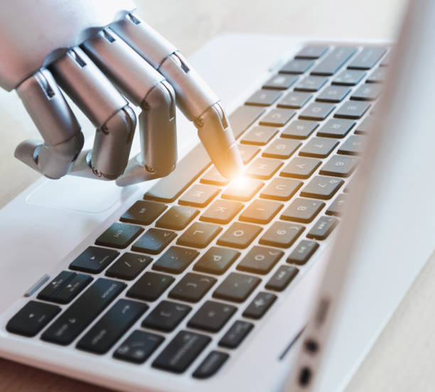istock Robot hands and fingers point to laptop button advisor chatbot robotic artificial intelligence concept with light effect 1156214691