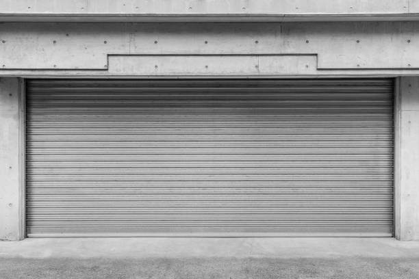 istock Garage building made of concrete with roller shutter doors 1156216516