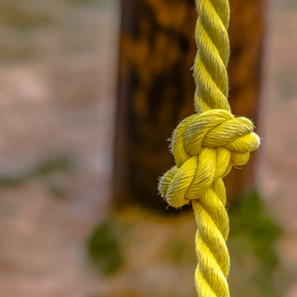 istock Square frame Close up view of a knotted yellow rope with dirt on the surface 1156218504