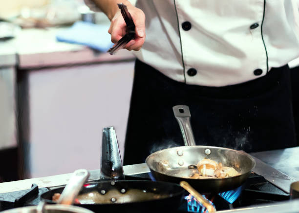 istock Chef cooking food in the kitchen, Chef preparing food 1156219420