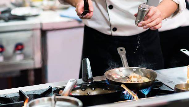 istock Chef cooking food in the kitchen, Chef preparing food 1156219422