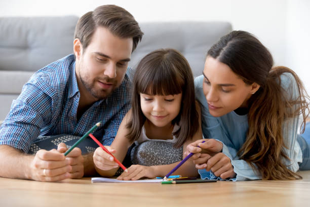 istock Loving parents relax drawing together with small daughter 1156224818