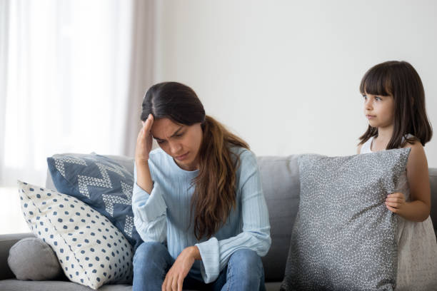 istock Little child confused by mom suffer health problem feel unwell 1156224837