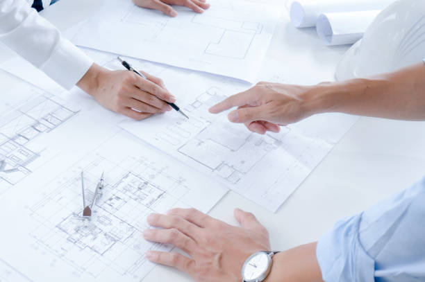 istock Colleagues interior designer Corporate Achievement Planning Design on blueprint Teamwork Concept with compasse. 1156226974