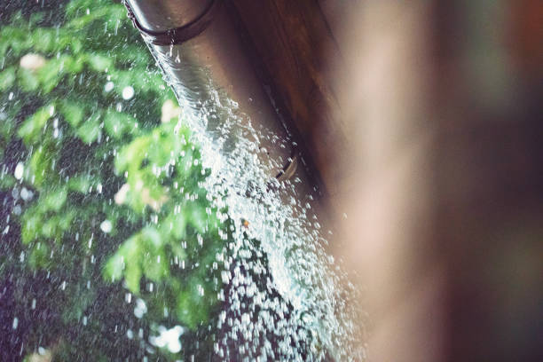 Heavy rain overflowing Roof Gutters