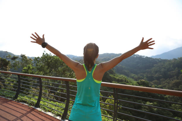 istock Woman runner outstretched arms on spring morning 1156227765