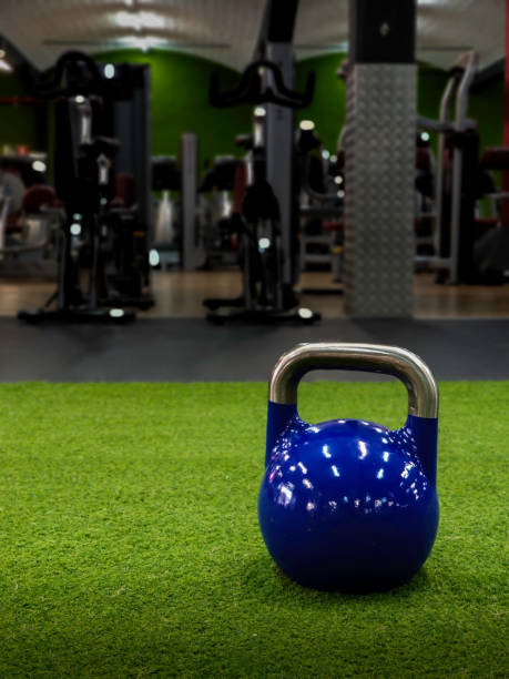 istock Kettlebell at a gym with static bikes on the background with copy space 1156230074