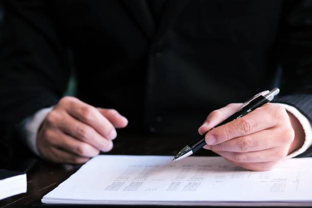 istock Businessman analyzing investment charts and pressing calculator buttons over documents. Accounting Concept. 1156230099