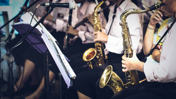trumpeter plays her trumpet in the band trumpeter plays her trumpet in the band during live concert wind instrument stock pictures, royalty-free photos & images