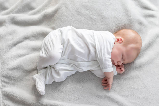 istock Top view of newborn boy sleeping on a blanket 1156236073