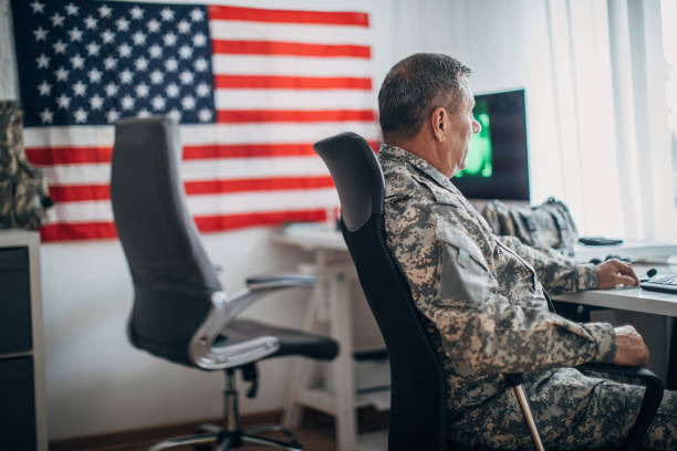 istock Senior man in military uniform working 1156236123