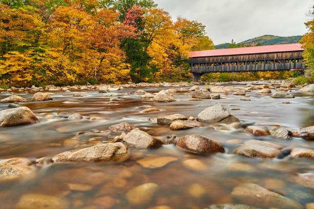 istock Swift River and old covered bridge at autumn 1156236250