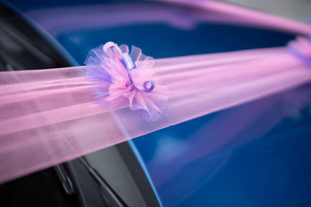 Wedding car decoration purple ribbon on blue car