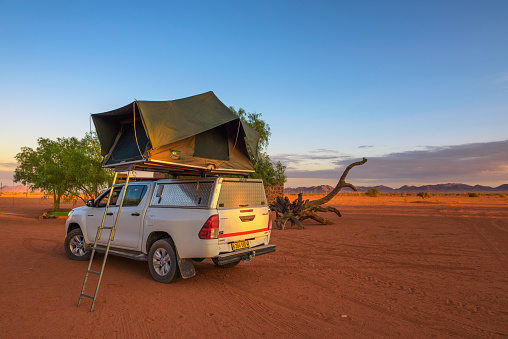 Betta, Namibia - March 27, 2019 : Tent located on the roof of a pickup 4x4 car in a desert camp