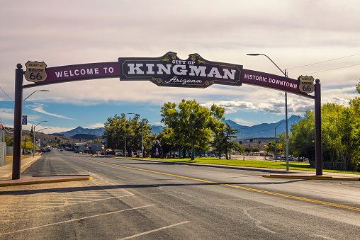 Kingman, Arizona, USA - October 24, 2018: Welcome to Kingman downtown, a wide arched street sign located on historic route 66.
