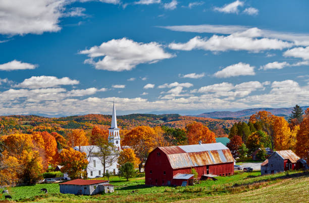 istock Church and farm with red barn at autumn 1156239051