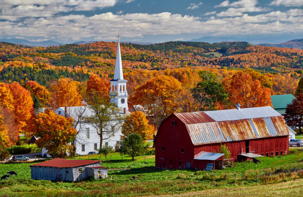 istock Church and farm with red barn at autumn 1156239053