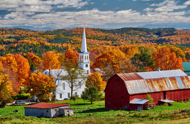 istock Church and farm with red barn at autumn 1156239054