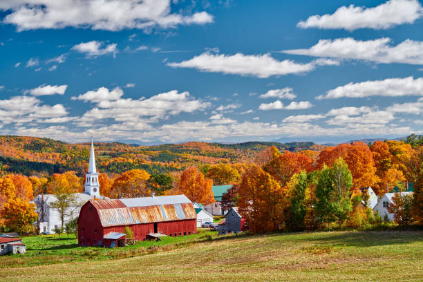 istock Church and farm with red barn at autumn 1156239069