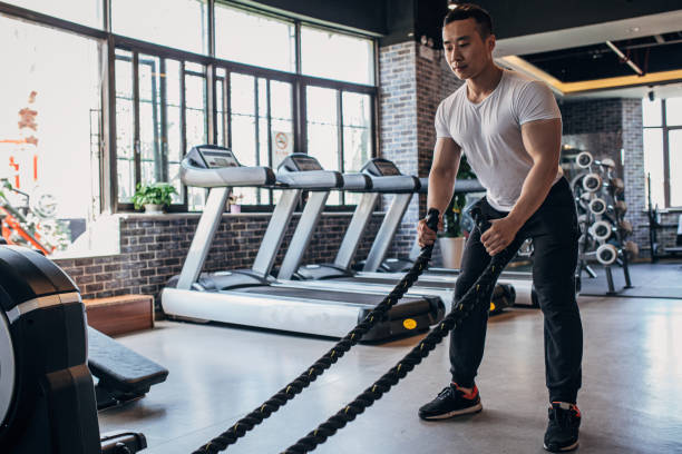istock Chinese bodybuilder exercising with ropes 1156241734