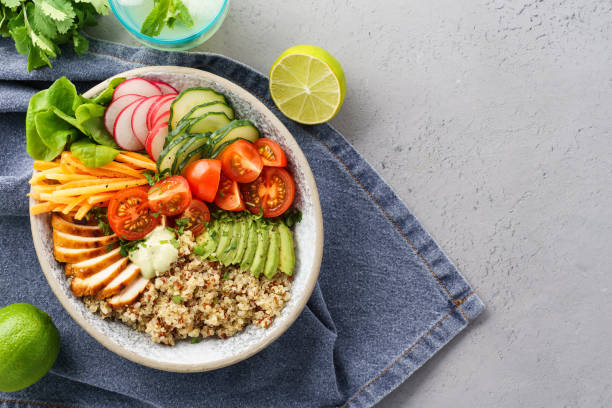 istock Healthy lunch bowl with chicken, fresh vegetables and quinoa. 1156246310