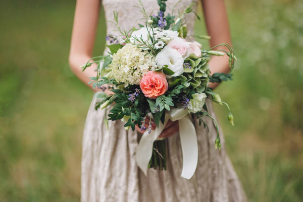 istock Wedding bouquet in bride's hands. White and pink roses. Fine art. 1156247378