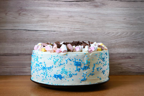 istock Large festive cake decorated with chocolate chips, marshmallows. Copy space for inscriptions. 1156247535