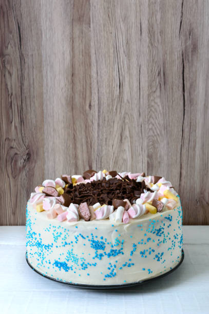 istock Large festive cake decorated with chocolate chips, marshmallows. Copy space for inscriptions. 1156247539